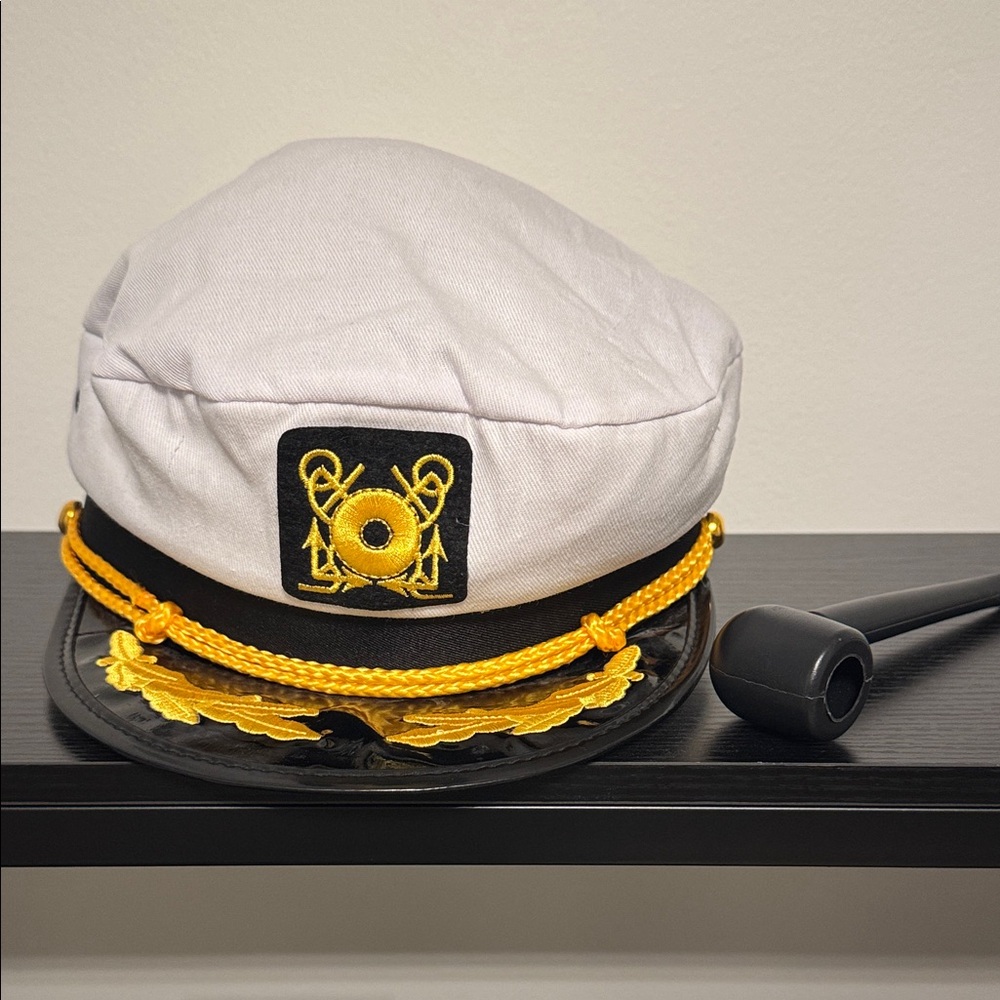 White and Black Captain's Hat with Gold Detailing and smoking pipe.